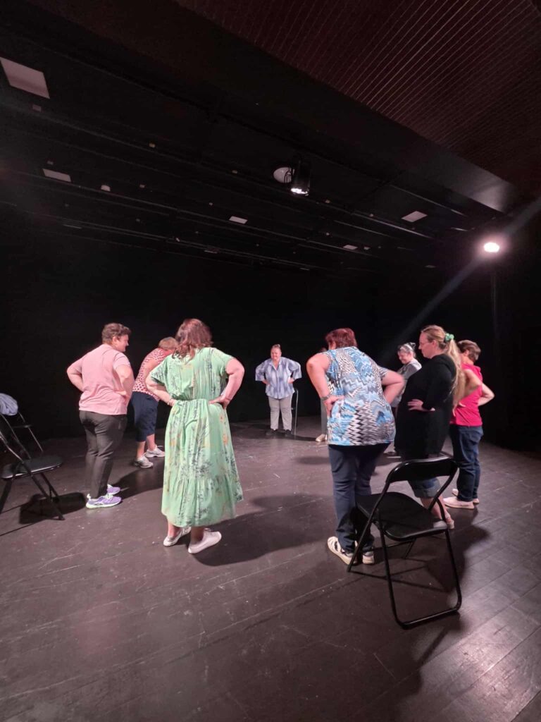 Group improvisation amongst the chairs on the theatre stage
