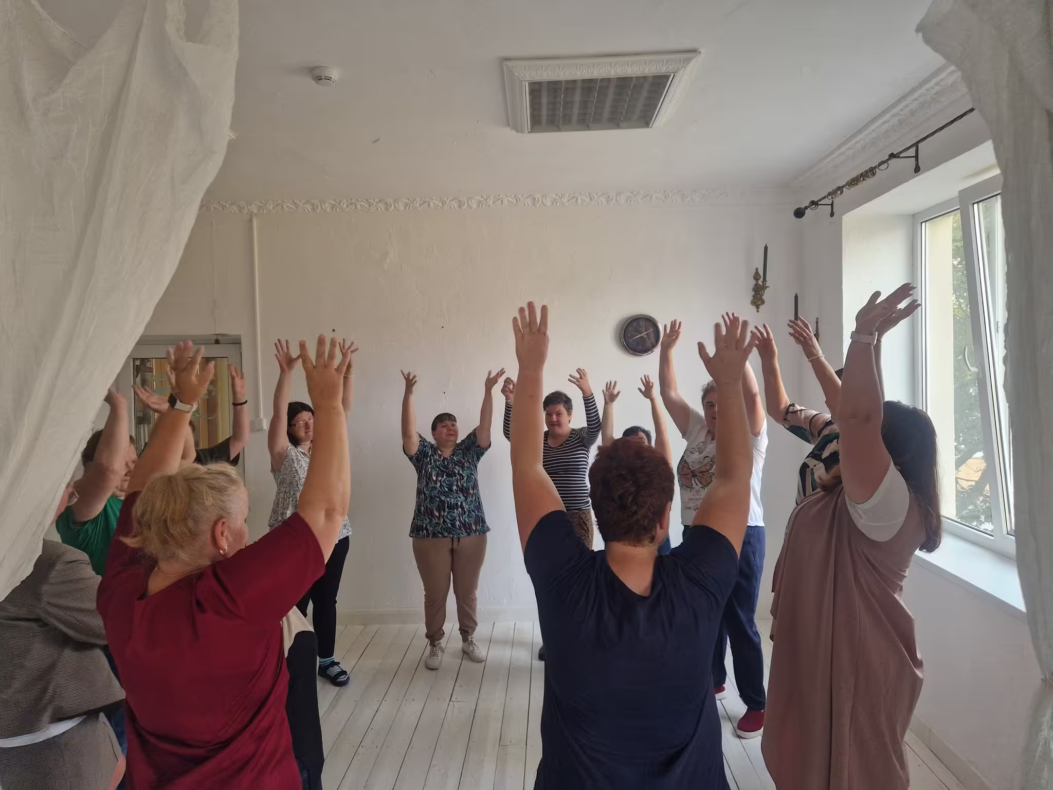 Teatro grupė atlieka bendrą judesio pratimą